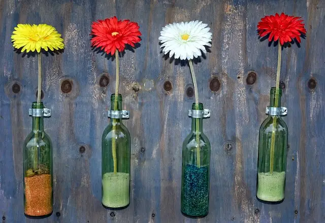 Display flowers in old wine bottles