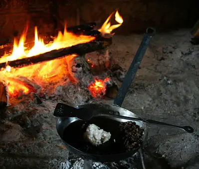 cooking with cast iron on a campfire