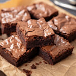 Freshly baked homemade brownies on parchment paper