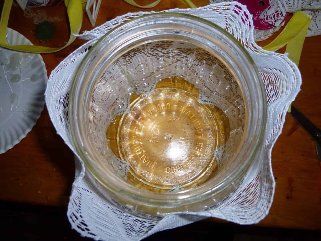 Excess lace at mouth of jar