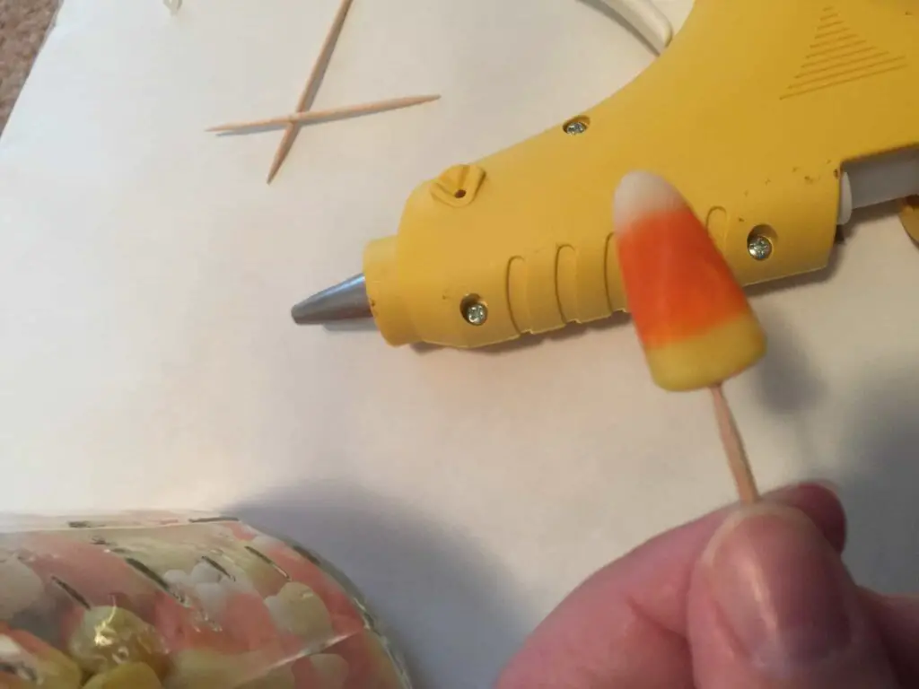 Use a toothpick to make hole in candy corn
