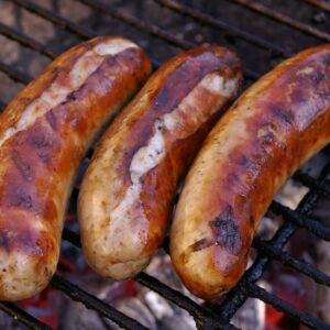 three sausage on a grill