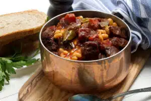 stone soup recipe in silver pot with veggies and meat