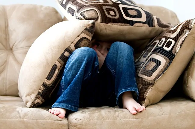 Little boy making pillow fort