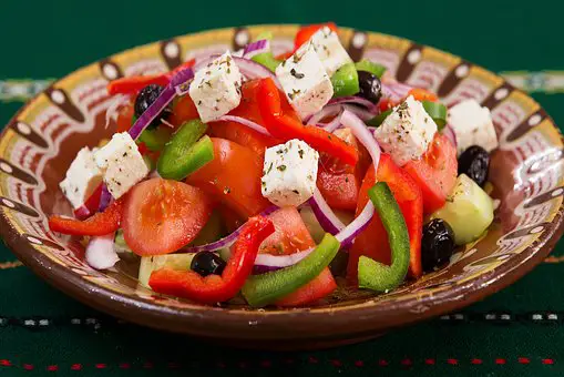 colorful salad with peppers tomatoes onions and feta cheese