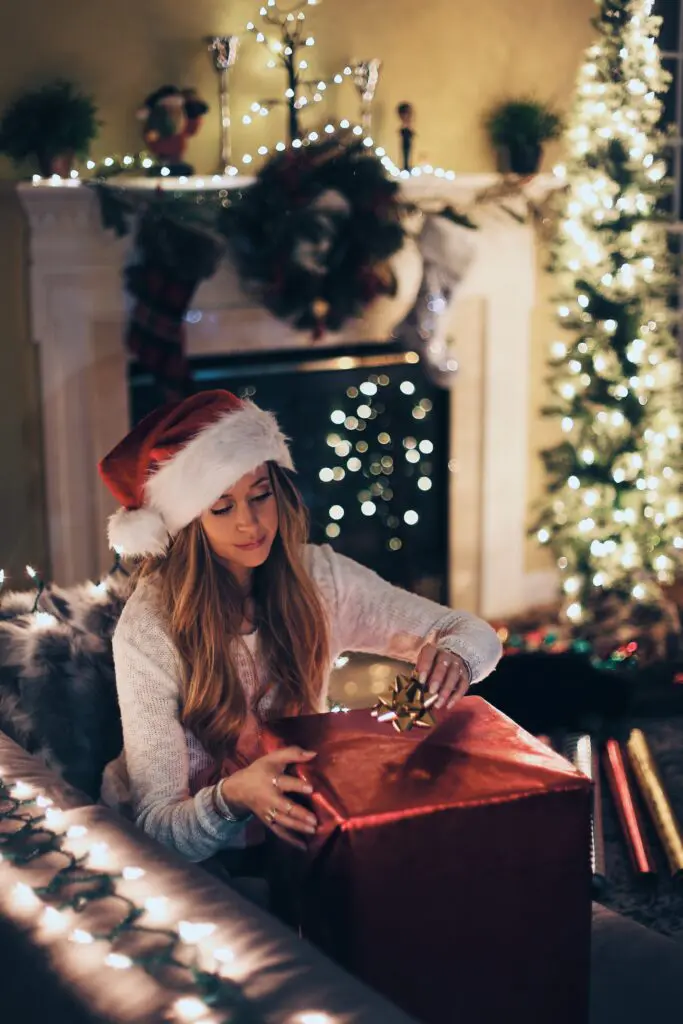 girl gift wrapping at Christmas