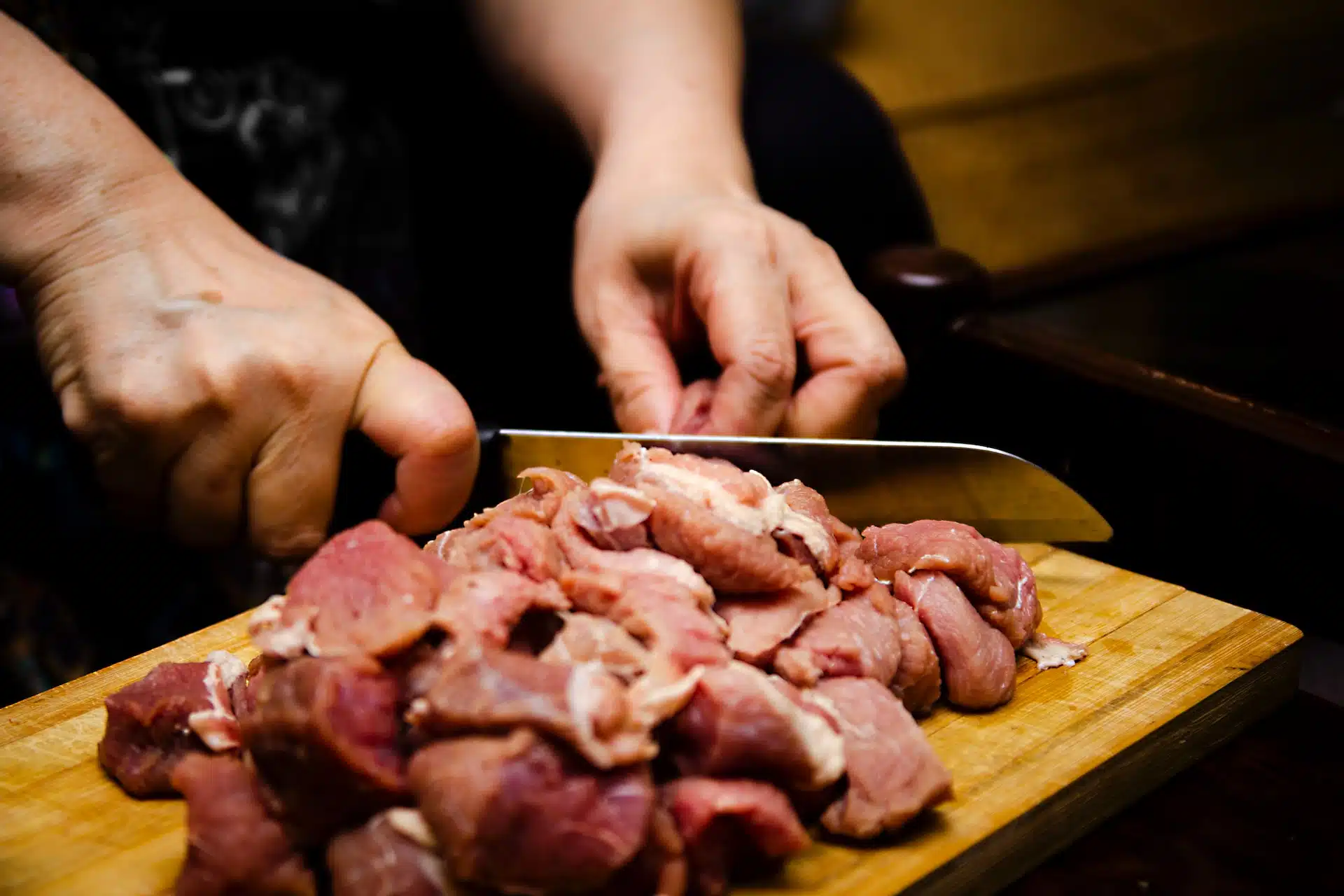 person slicing pepper steak for crockpot