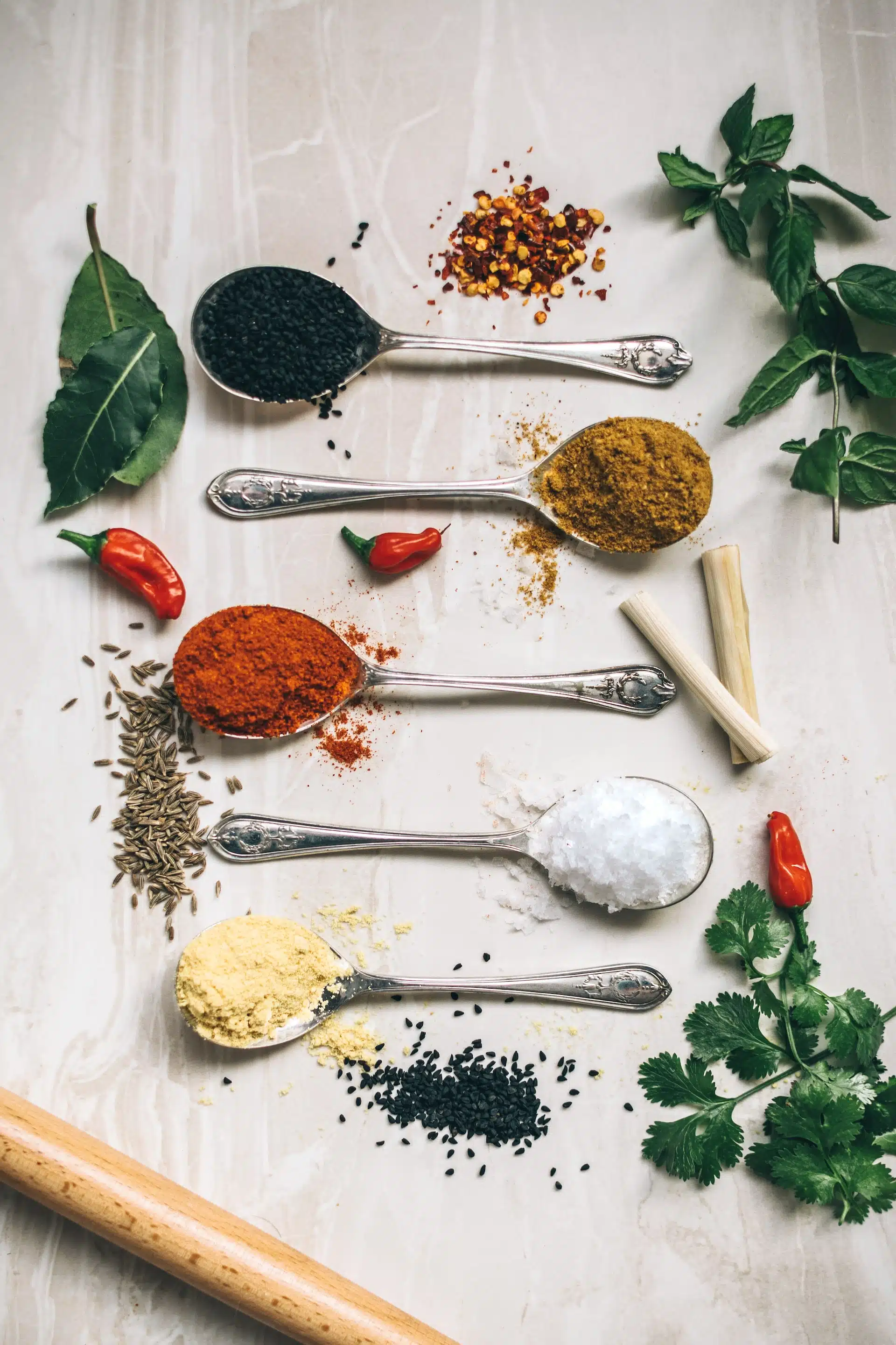 colorful spices and herbs on white background