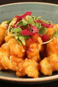General Tso Crockpot Chicken with green and red pepper garnish