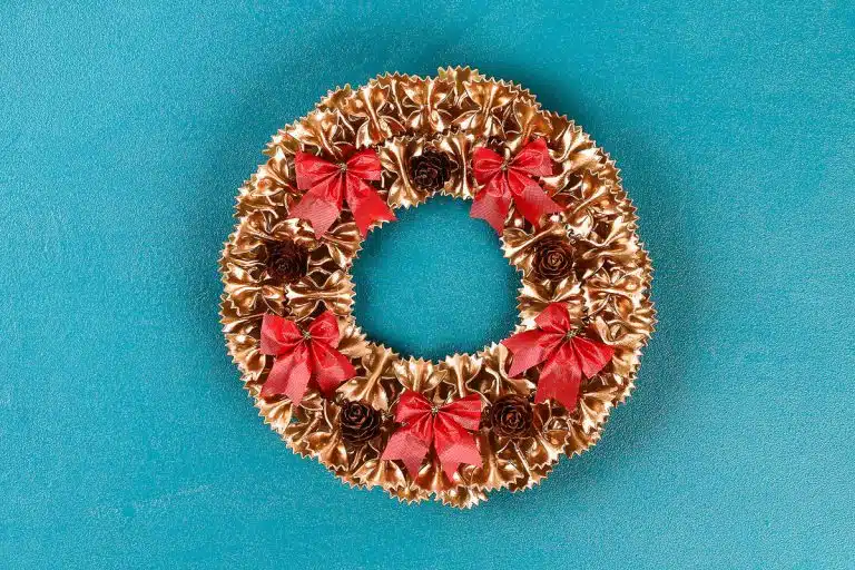 Diy Christmas pasta wreath on blue background. Gift idea, decor Christmas, Xmas, New Year. Step by step. Top view. Process kid children craft. Workshop.