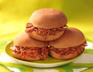 3 BBQ turkey sliders stacked on a green plate