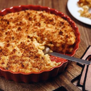 macaroni and cheese in red round serving dish
