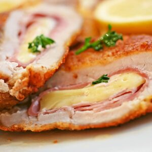 slice of pork cordon blue with ham and cheese wrapped in pork