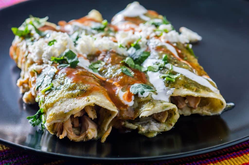 3 turkey enchilada verde covered with sour cream and red sauce