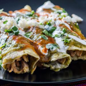 3 turkey enchilada verde covered with sour cream and red sauce