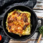 Delicious baked lasagna in a pan, Italian traditional cuisine. White wooden background. Top view.