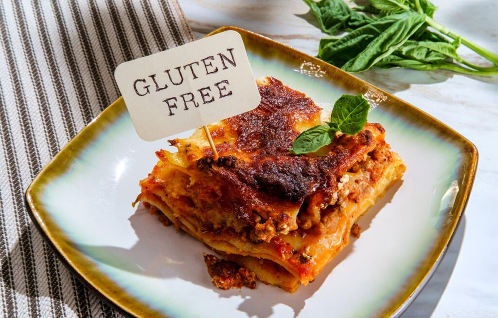 piece of lasagna with small sign reading gluten free