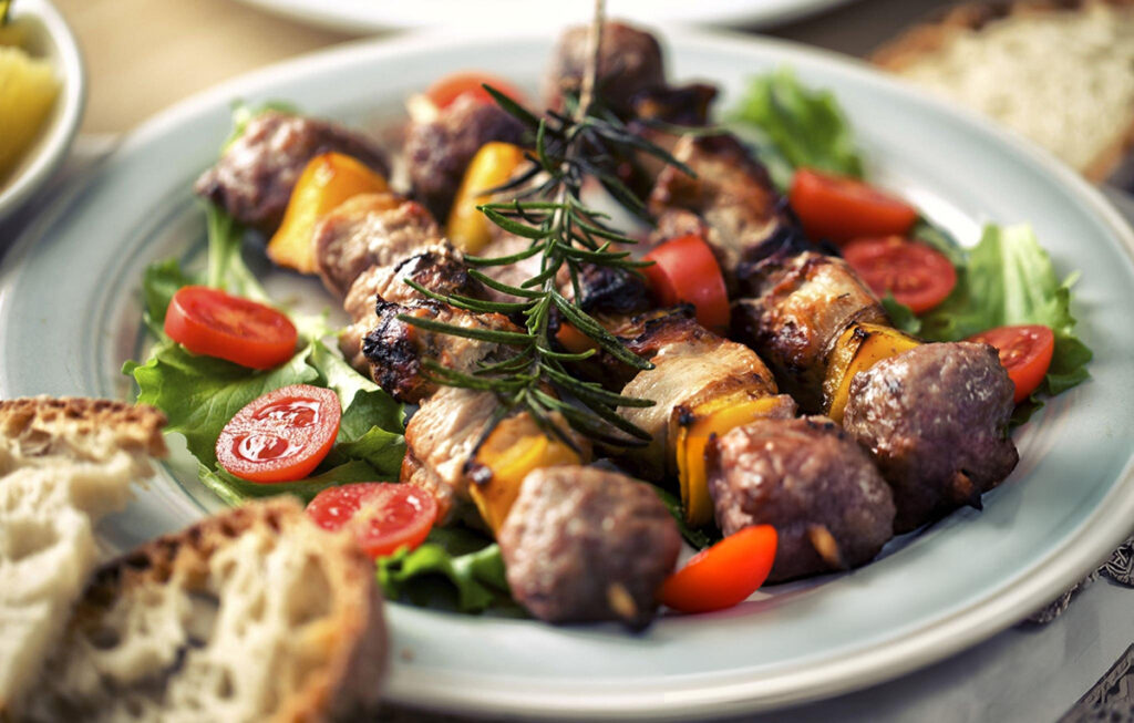 side salad and rosemary herb with sausage skewers