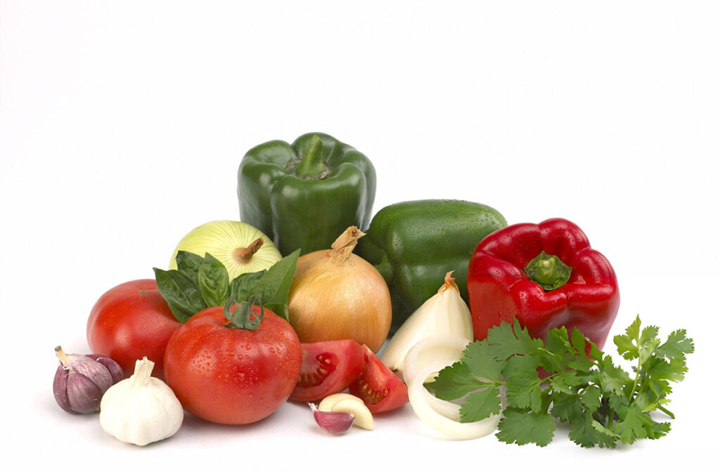 peppers, onions, tomatoes with garlic and herbs for sausage skewers