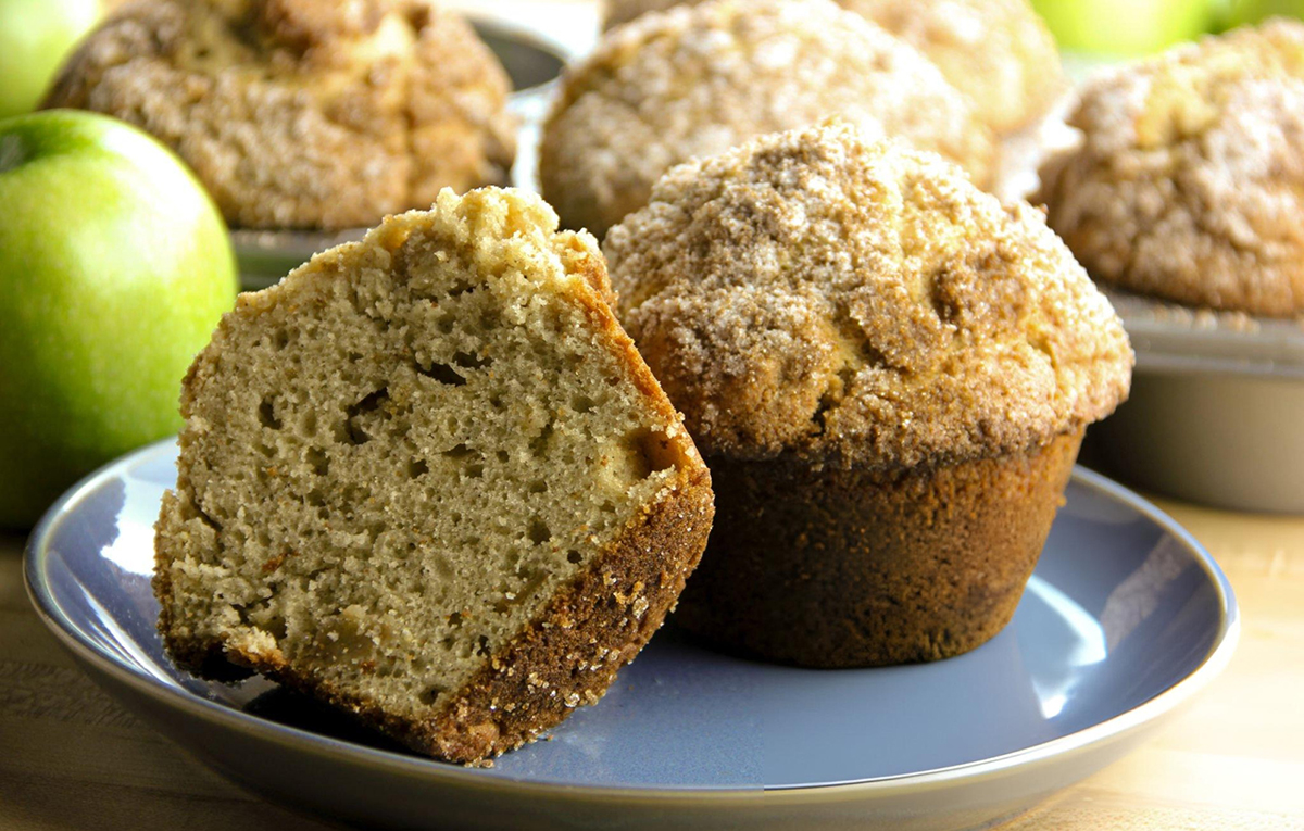 cut apple cinnamon muffin on blue plate